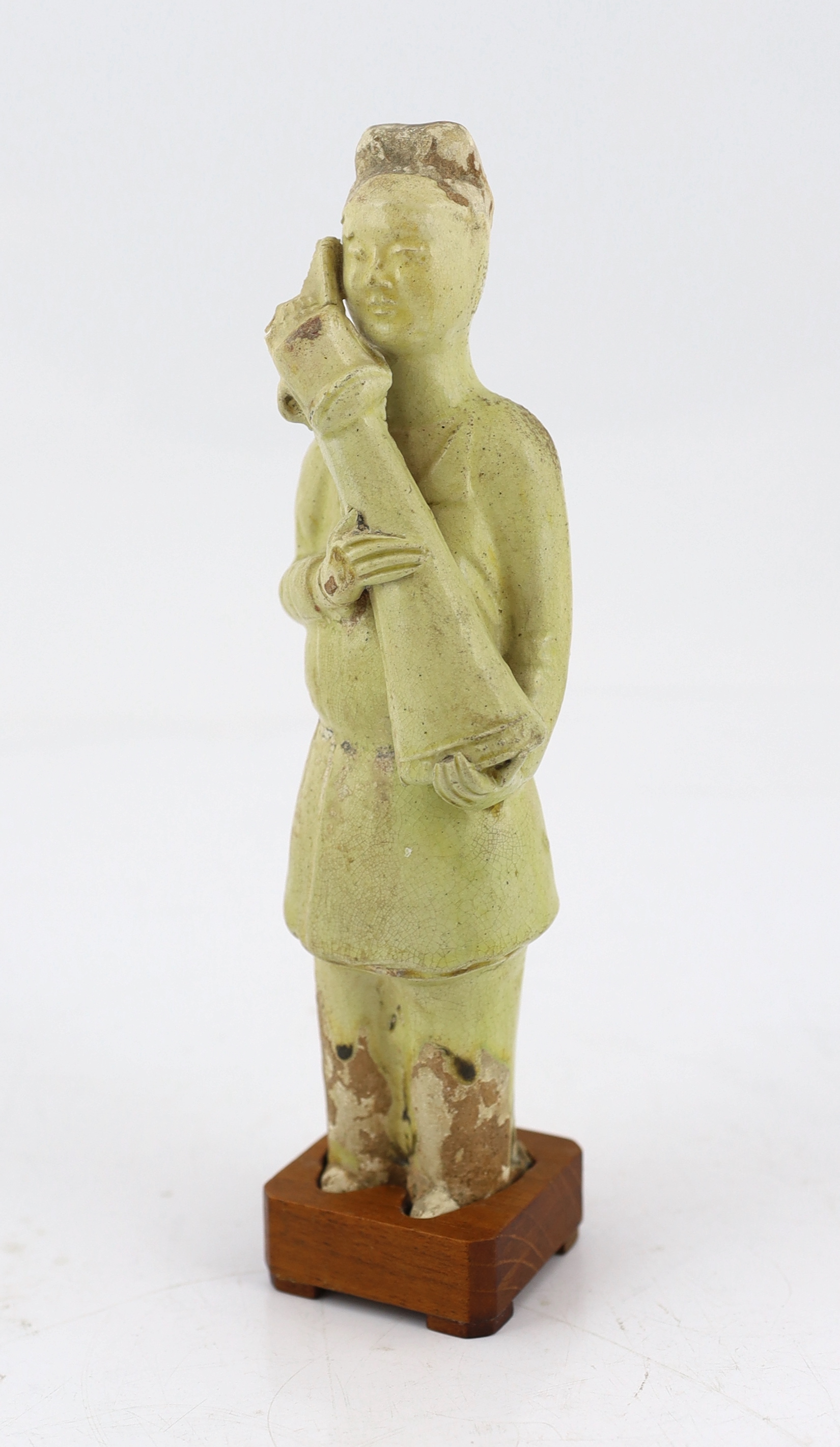 A Chinese pale green glazed pottery figure of an attendant, Tang dynasty (618-906 AD)